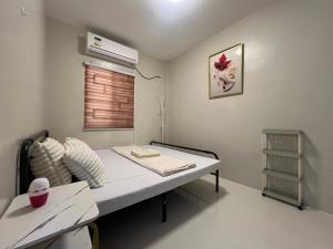 a hospital room with a bed and a air conditioner at Hayat Apartment Digos City in Dawis