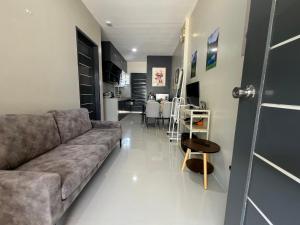 a living room with a couch and a table at Hayat Apartment Digos City in Dawis