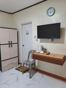a home office with a desk and a tv on the wall at G & B Transient House in San Jose