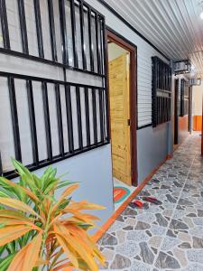 a hallway of a house with a door and a plant at G & B Transient House in San Jose