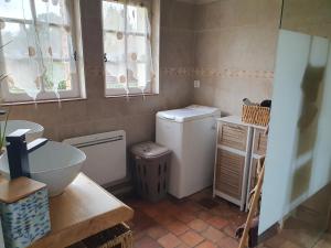 a small bathroom with a sink and a washing machine at Gite les Bruyères in Salbris +17 photos