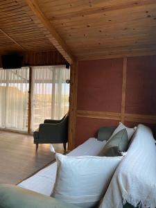 a bed in a room with a wooden ceiling at CasaMora in Edremit
