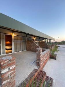 a brick building with a roof and a brick wall at CasaMora in Edremit
