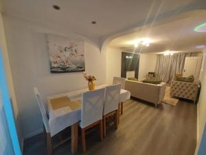 a living room with a dining table and a couch at Private Home Grays in Orsett