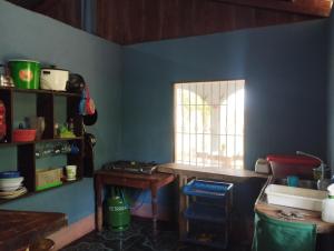 a blue room with a window and a table at Rancho Belen in Isla de Ometepe