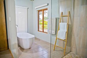 a bathroom with a large tub and a glass shower at Collen Pillar Hotels, Windsor Royale in Athol +42 photos