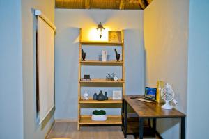 a room with a desk and a laptop on a shelf at Collen Pillar Hotels, Windsor Royale in Athol