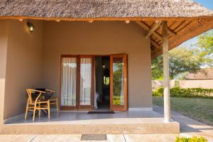 a small house with a thatch roof at Collen Pillar Hotels, Windsor Royale in Athol