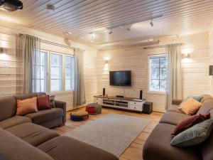 a living room with two couches and a flat screen tv at Holiday Home Tervakko by Interhome in Luosto +27 photos