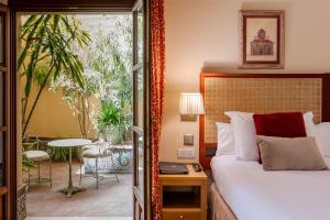a hotel room with a bed and a table at Casa Romana Hotel Boutique in Seville