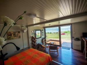 a bedroom with a bed and a view of a field at Od svitanja do sumraka in Golubac