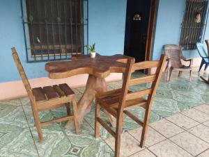 a wooden table and two chairs and a table and chairs at Rancho Belen in Isla de Ometepe