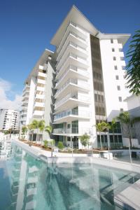 a large building with a swimming pool in front of it at m1 Resort in Maroochydore