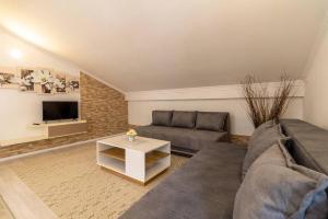 a living room with a couch and a table at Villa San in Neum +64 photos