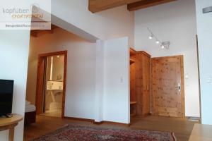 a room with a large white wall and a door at Sporthotel Christophorus in Kappl