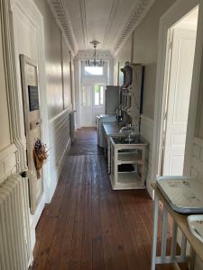 a hallway of a kitchen with a wooden floor at La glacière in Périgueux