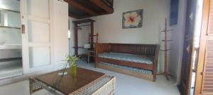 a living room with a bench and a table at Aloha Residence I in Praia do Forte +190 photos