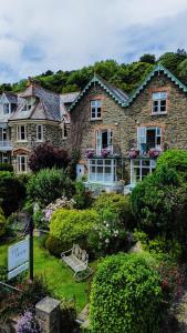 a large stone house with a garden in front of it at Lee House in Lynton