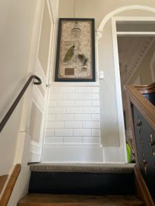 a stairway with a picture on the wall at La glacière in Périgueux +28 photos