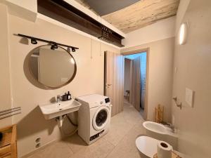 a bathroom with a sink and a washing machine at Palazzo Giulietta in Verona