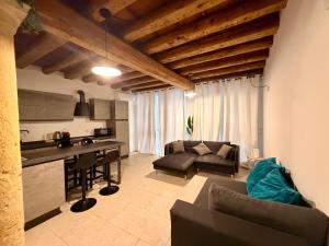 a kitchen and living room with a couch and a table at Palazzo Giulietta in Verona