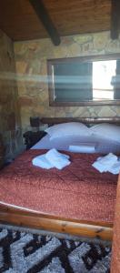 a bedroom with a bed with towels on it at Kalavrita Mons in Kalavrita