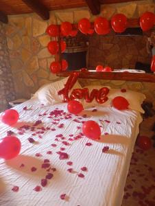 a bed with red bleeding love written on it at Kalavrita Mons in Kalavrita