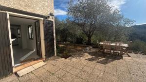 a table and chairs on a patio with a view at Charming apartment with stunning mountain views in Levens +3 photos