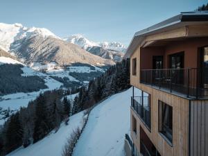 a balcony of a building with a view of the mountains at Lahnerhof Chalets - Mountain view and Sauna inclusive in Lutago