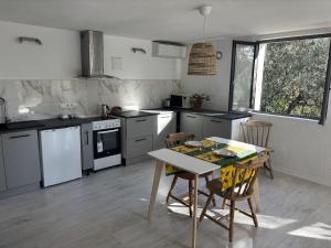 a kitchen with a table and a table and chairs at Charming apartment with stunning mountain views in Levens