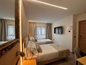 a hotel room with two beds and a mirror at ND Hoteles in Valdemoro