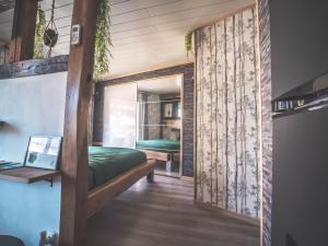 a bedroom with a green bed and a window at Domaine des 7 cépages in Arsonval +136 photos