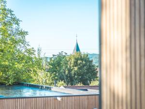 a view of a swimming pool from a window at Domaine des 7 cépages in Arsonval