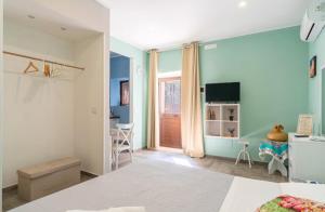 a bedroom with a bed and a room with a window at Casacecilia relax in Syracuse