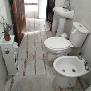 a bathroom with a toilet and a sink at Entre Tanto in Luyaba +23 photos