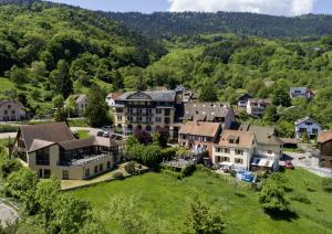 an aerial view of a town in the mountains at LE CLOS DES SOURCES Hôtel & Spa in Thannenkirch