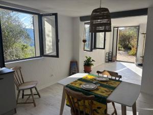 a kitchen and dining room with a table and chairs at Charming apartment with stunning mountain views in Levens