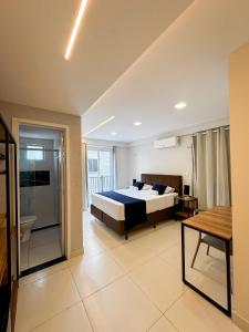a large bedroom with a bed and a bathroom at Home Studio in Sobral