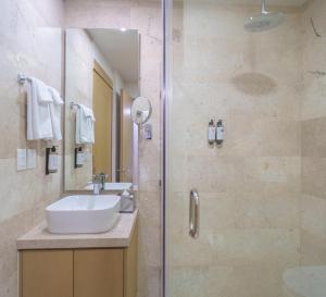 a bathroom with a sink and a shower at abba Suites Playa del Carmen in Playa del Carmen +29 photos