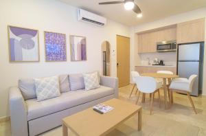 a living room with a couch and a table at abba Suites Playa del Carmen in Playa del Carmen