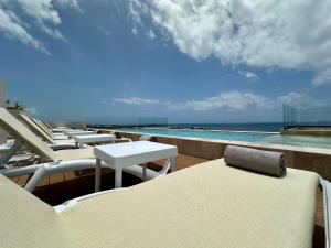a row of chairs and tables on a balcony with the ocean at abba Suites Playa del Carmen in Playa del Carmen