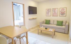 a living room with a couch and a table at abba Suites Playa del Carmen in Playa del Carmen