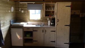 a small kitchen with a sink and a window at 5 persoons lodge in Witmarsum