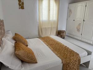 a bedroom with a large bed with pillows on it at Casa Madame Aïcha in Sousse +38 photos