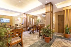 a restaurant with wooden walls and tables and potted plants at Divya Boutique Inn in Kathmandu