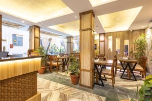 a restaurant with wooden walls and tables and chairs at Divya Boutique Inn in Kathmandu