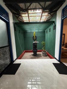 a room with a table and a green wall at Peacock grand resort in Kataragama