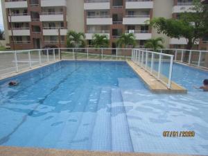 a large swimming pool in front of a building at Dunas de Guarajuba in Camacari +2 photos
