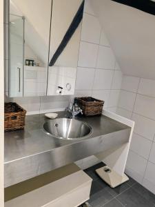 a bathroom with a sink and a mirror at Op Vakantie bij Nicole in Putten +27 photos