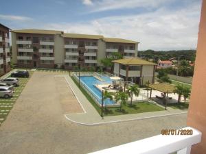 a view of an apartment complex with a swimming pool at Dunas de Guarajuba in Camacari